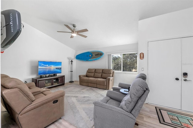 living room featuring light hardwood / wood-style flooring, ceiling fan, and vaulted ceiling