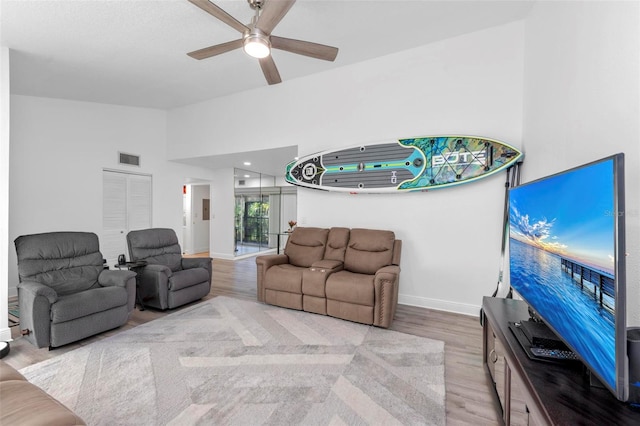 living room featuring light wood-type flooring and ceiling fan