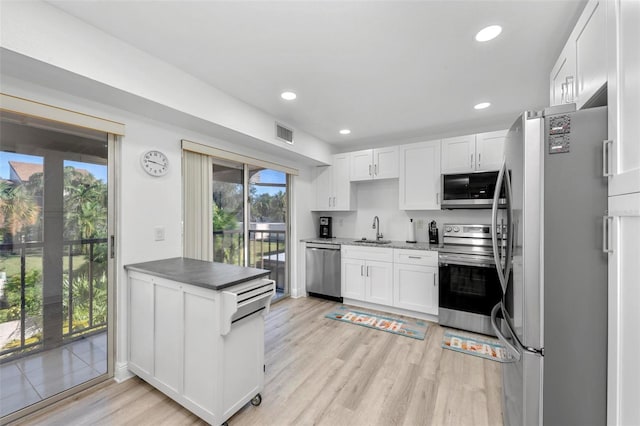 kitchen featuring light hardwood / wood-style flooring, white cabinetry, stainless steel appliances, and sink