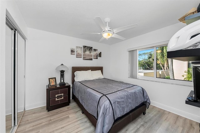 bedroom featuring a closet, light wood-type flooring, and ceiling fan