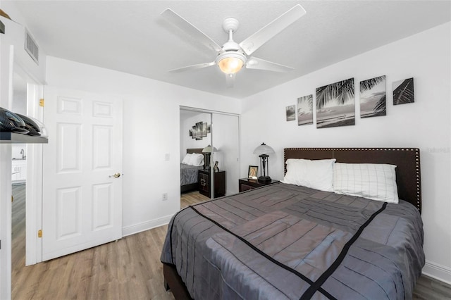 bedroom with a closet, ceiling fan, and hardwood / wood-style floors