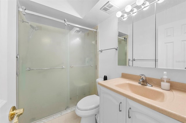 bathroom featuring vanity, toilet, tile patterned floors, and walk in shower