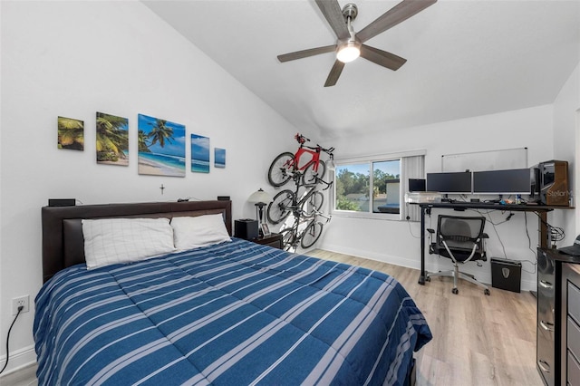 bedroom featuring light hardwood / wood-style flooring, lofted ceiling, and ceiling fan