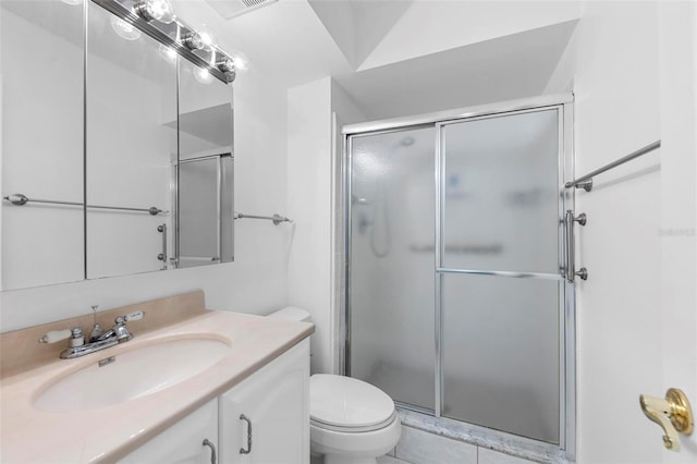 bathroom with toilet, walk in shower, vanity, and tile patterned floors