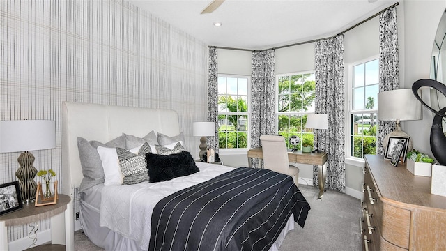 bedroom featuring light carpet and ceiling fan