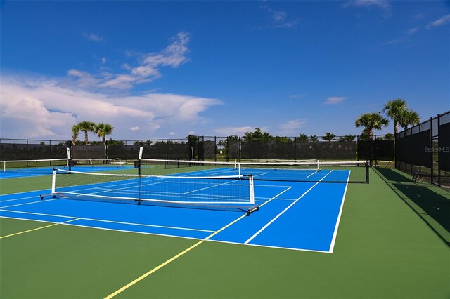 view of tennis court featuring basketball hoop