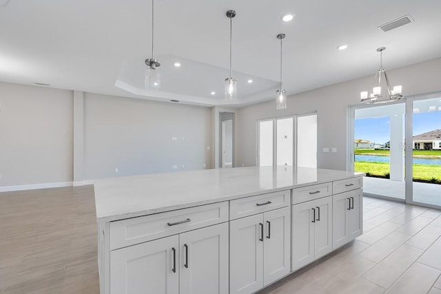 10442 Morning Mist, Sarasota, FL 34241 - kitchen with open floor plan, recessed lighting, light countertops, a chandelier, and white cabinetry