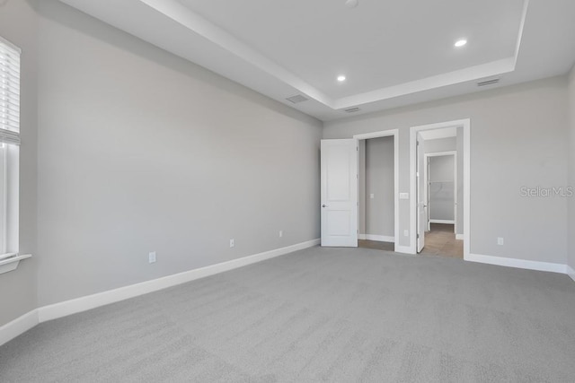 10442 Morning Mist, Sarasota, FL 34241 - unfurnished bedroom with carpet flooring, recessed lighting, a walk in closet, baseboards, and a raised ceiling