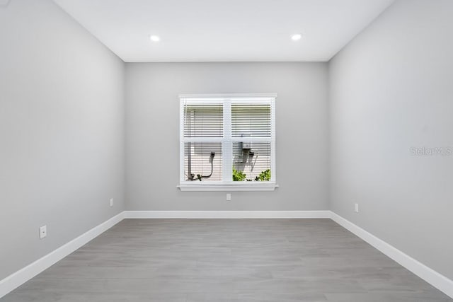 10442 Morning Mist, Sarasota, FL 34241 - unfurnished room featuring baseboards, light wood-type flooring, and recessed lighting
