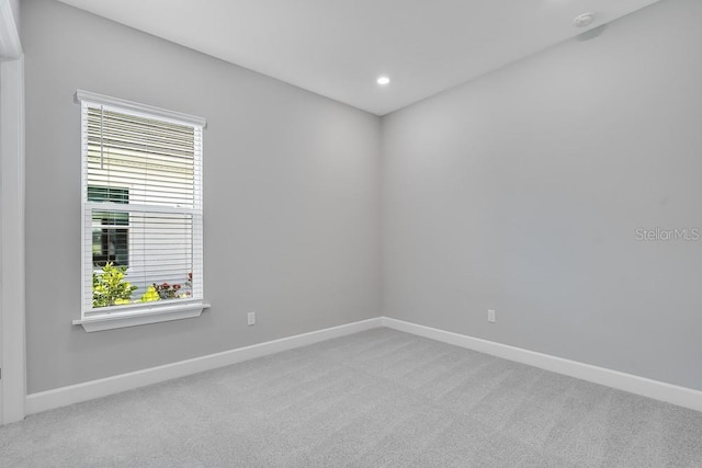 10442 Morning Mist, Sarasota, FL 34241 - empty room featuring light carpet, baseboards, recessed lighting, and a smoke detector