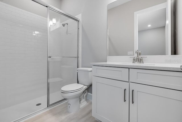 10442 Morning Mist, Sarasota, FL 34241 - full bath featuring toilet, a stall shower, vanity, wood finished floors, and recessed lighting