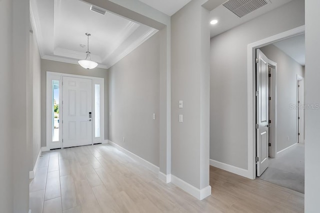 10442 Morning Mist, Sarasota, FL 34241 - foyer entrance with ornamental molding, light wood-style flooring, baseboards, and a raised ceiling