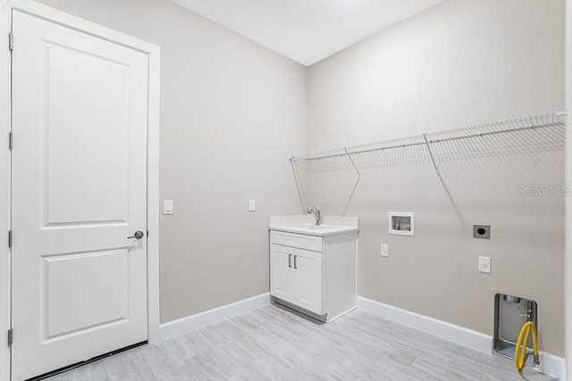 10442 Morning Mist, Sarasota, FL 34241 - washroom with hookup for an electric dryer, cabinet space, baseboards, hookup for a washing machine, and light wood-style floors