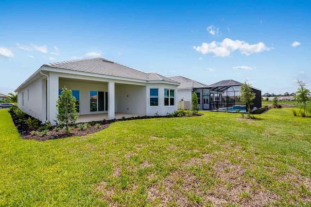 10442 Morning Mist, Sarasota, FL 34241 - rear view of house with a yard, a lanai, and stucco siding