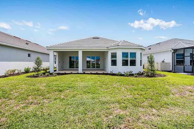 10442 Morning Mist, Sarasota, FL 34241 - rear view of property with a yard, a tiled roof, and stucco siding