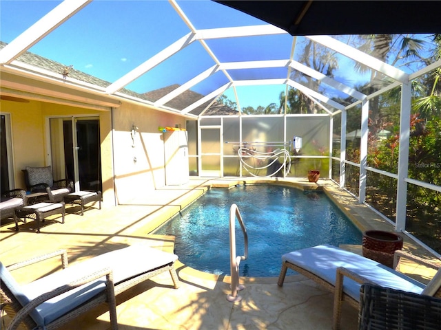 view of swimming pool featuring a patio area and glass enclosure