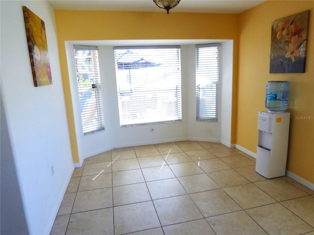 unfurnished dining area featuring plenty of natural light and light tile patterned flooring