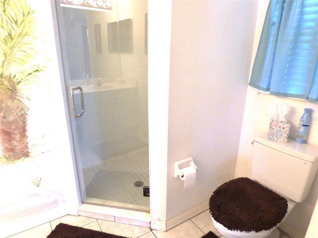 bathroom with tile patterned floors, toilet, and walk in shower