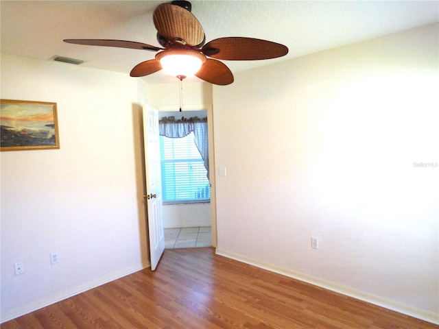 spare room with ceiling fan and wood-type flooring