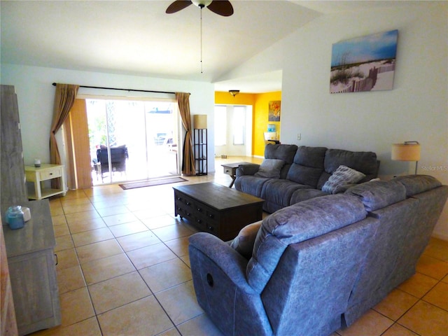 tiled living room featuring ceiling fan and vaulted ceiling