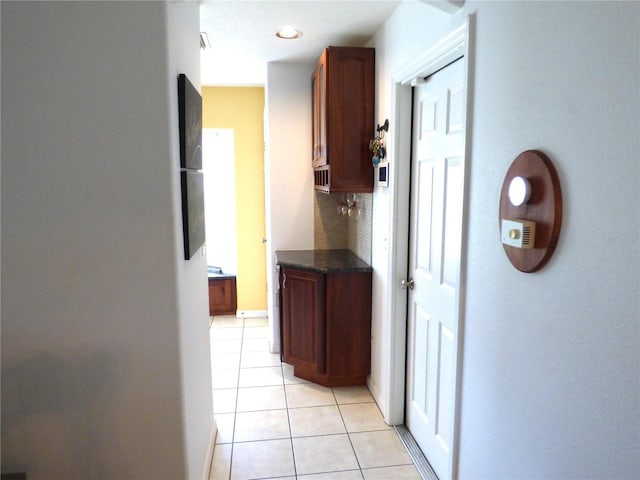 hall featuring light tile patterned flooring