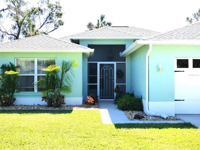 entrance to property featuring a lawn