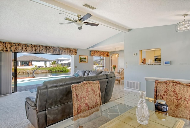 carpeted living room with vaulted ceiling with beams, a textured ceiling, and ceiling fan with notable chandelier