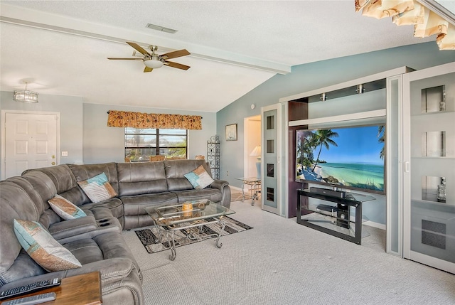 living room with ceiling fan, lofted ceiling with beams, a textured ceiling, and carpet floors