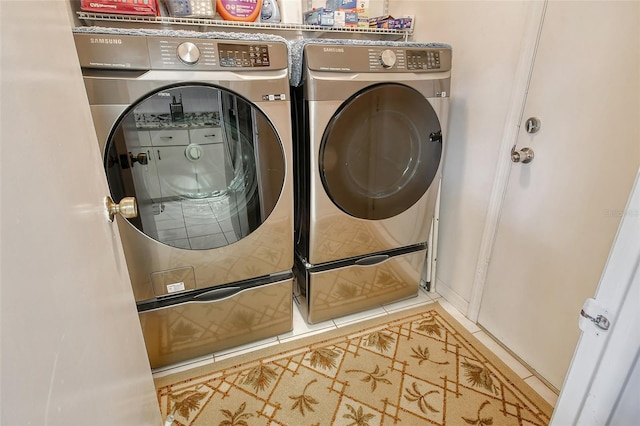 laundry area with tile patterned flooring and separate washer and dryer