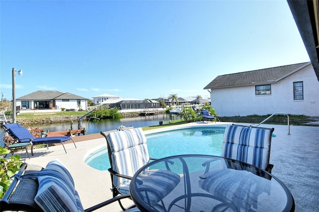 view of swimming pool with a water view and a patio