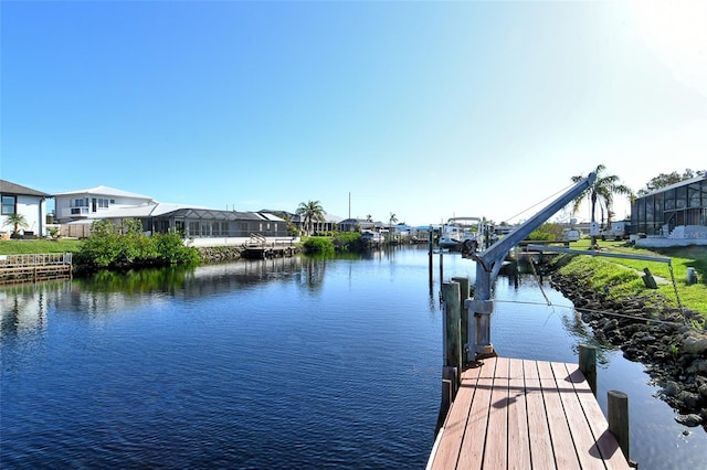 view of dock with a lanai and a water view