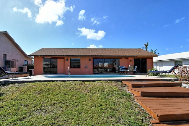 rear view of house with a yard and a patio area