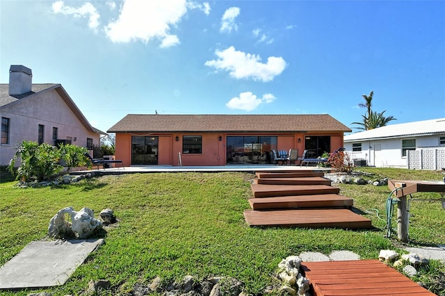 rear view of property with a lawn