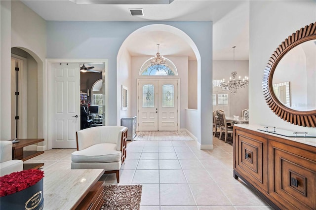 entryway featuring an inviting chandelier and light tile patterned floors