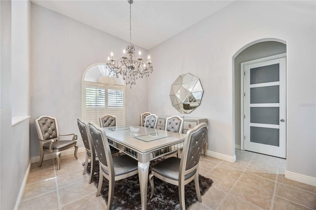 dining room with vaulted ceiling, light tile patterned flooring, and an inviting chandelier