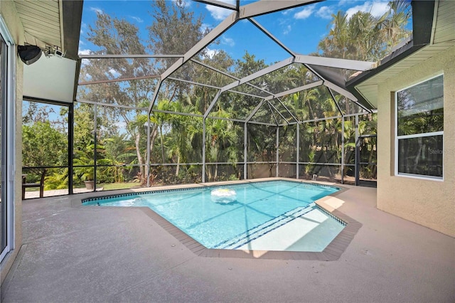 view of pool with a lanai and a patio