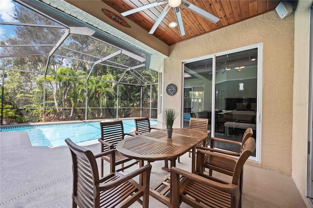 view of patio / terrace with ceiling fan and glass enclosure