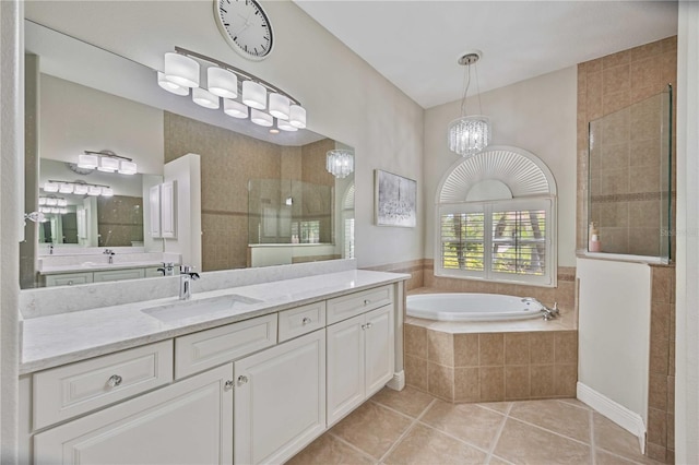 bathroom featuring a chandelier, tile patterned floors, separate shower and tub, and vanity