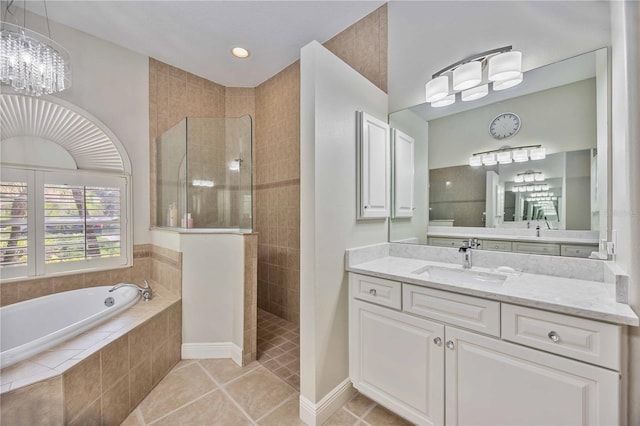 bathroom with tile patterned floors, vanity, and independent shower and bath