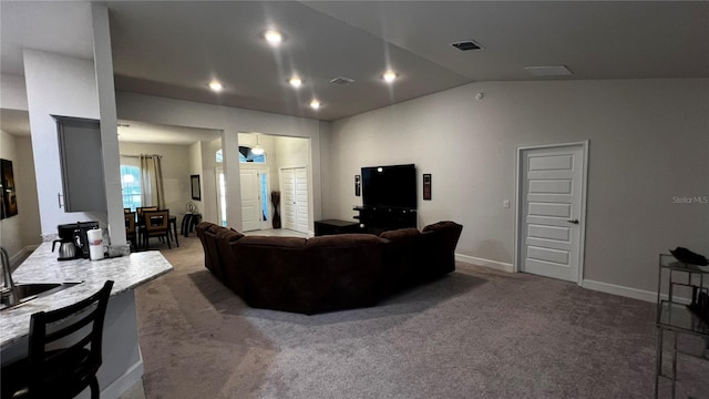 carpeted living room with lofted ceiling