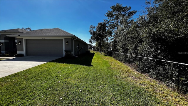 view of property exterior with a garage and a lawn