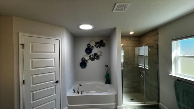 bathroom with shower with separate bathtub