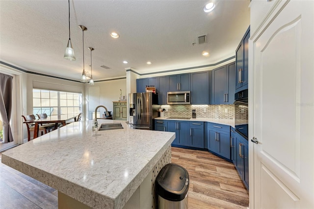 kitchen featuring light hardwood / wood-style floors, a center island with sink, sink, black appliances, and blue cabinetry