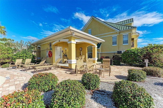 rear view of property featuring a patio