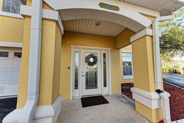 view of exterior entry featuring a garage