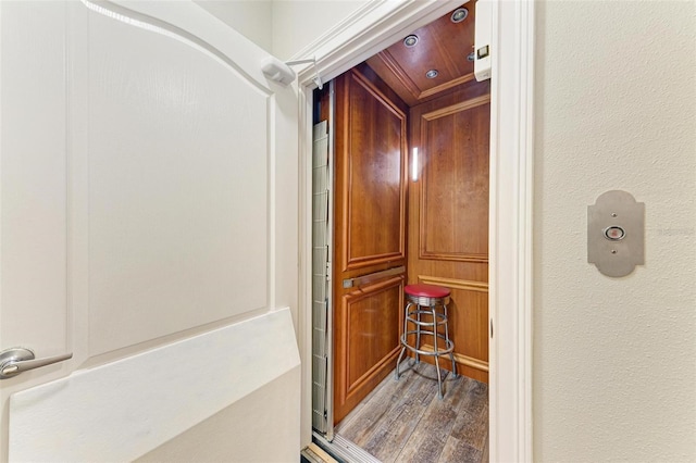 details with elevator and wood-type flooring