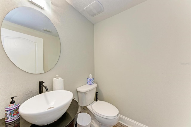 bathroom featuring sink and toilet