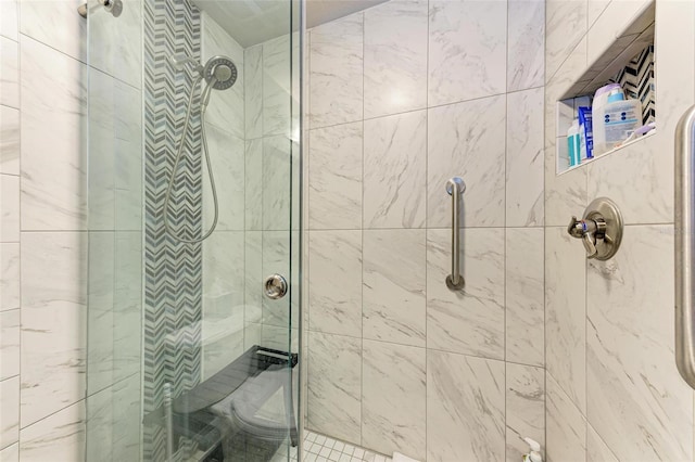 bathroom featuring a shower with shower door