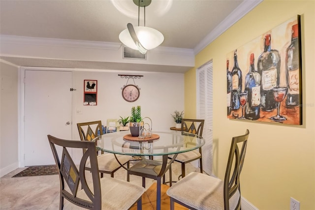 dining room with a textured ceiling and crown molding