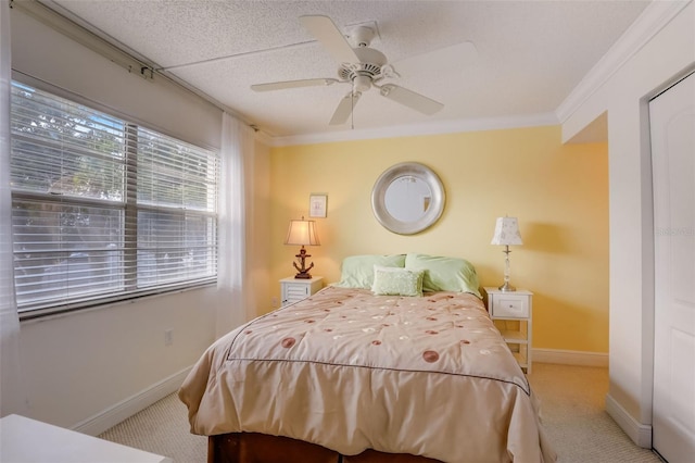 bedroom featuring a textured ceiling, ceiling fan, light colored carpet, and crown molding